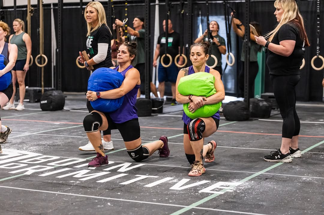 Athlete performing lunges with sandbag